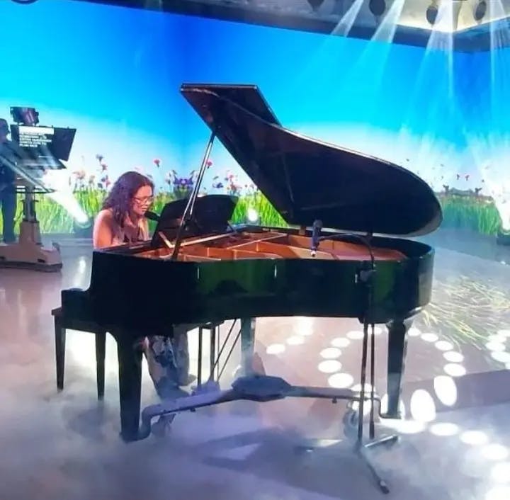 Nikole enchanting the audience with her piano skills on a live TV show in Puerto Rico.
